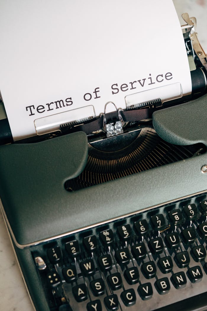Mastering the First Impression: Your intriguing post title goes here Close-up of a vintage typewriter typing Terms of Service on paper.